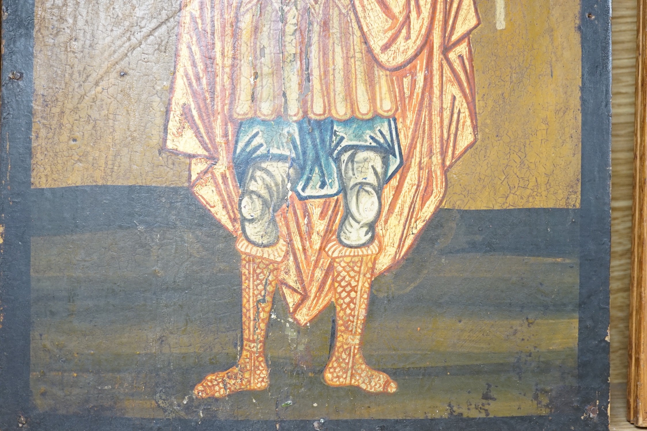 Greek School, tempera on wooden panel, Icon of a standing saint holding a candle, 33 x 24.5cm